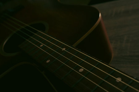 Close up of a acoustic guitar string and fingerboard with new strings. Photo of an old wooden guitar...