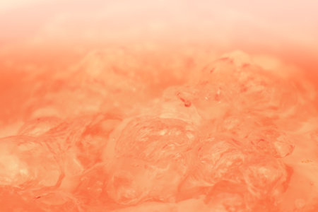 Abstract nude and peach fuzz color gradient background. Water surface. Clear water surface texture with splashes and bubbles. Abstract peach background.の写真素材