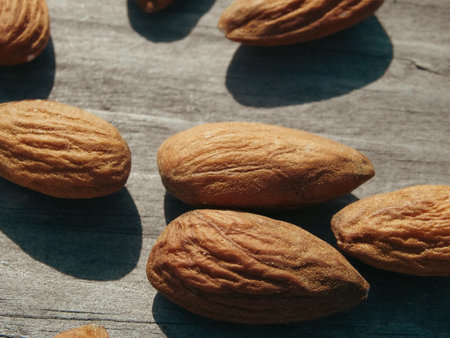 Almond nuts on gray wooden table background. Peeled almonds in on a wooden table.の写真素材