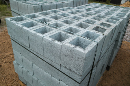 Hollow concrete wall blocks assembled on pallets. Finished products stacked on pallets on...