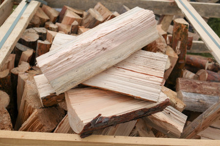 Picture of logs stacked on pile. Wooden texture. Chopped wood for winter heating of the fireplace....