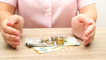 Woman hands with money on table. Saving money concept. Credit and debt concept.の写真素材