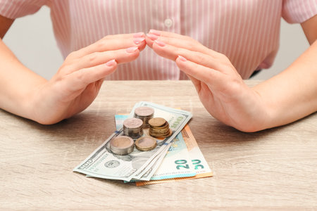 Woman hands with money on table. Saving money concept. Credit and debt concept.の写真素材