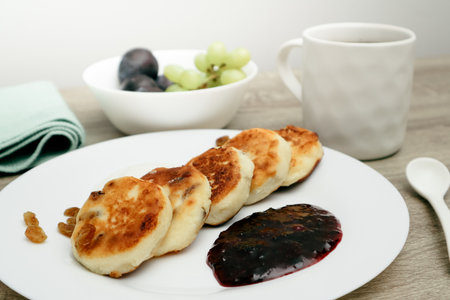 Cheesecake with jam placed on plate. Concept of a sweet dessert, teatime, and homemade baking.の写真素材