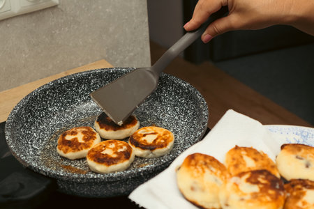 Fried Cheesecake. Panning food prepare in process. Home cooking, traditional recipes, and culinary preparation.の写真素材