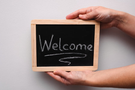 Welcome sign handwritten on the blackboard. Blackboard with text welcomeの写真素材