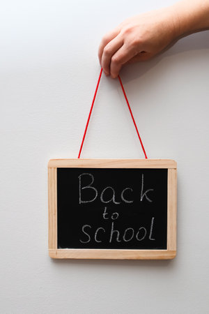 Back to school text written on black chalkboard. Inscription Back to School. After vacation go back to schoolの写真素材