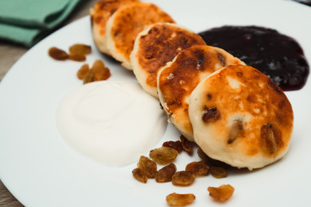 Classic homemade cheesecake with jam. Tasty homemade fried cheesecake. Cottage cheese pancakes fried or baked.の写真素材