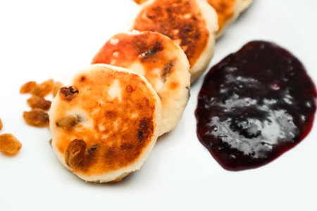 Classic homemade cheesecake with jam. Tasty homemade fried cheesecake. Cottage cheese pancakes fried or baked.の写真素材