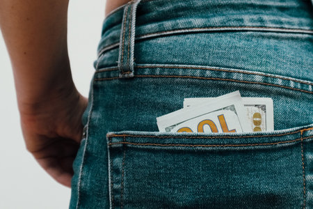 One hundred dollar bills in the back pocket of jeans. Money in the pocket of jeans Selective focus. Money in your pocket.の写真素材