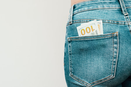 One hundred dollar bills in the back pocket of jeans. Money in the pocket of jeans Selective focus.の写真素材