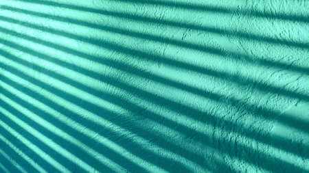 Minimal abstract background with shadow. Beautiful texture smooth stucco wall with shadow reflection. Effect for overlaying a photo or mockupの写真素材