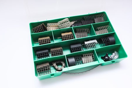 Open box with fishing accessories. Organized fishing tackle box displaying various tools