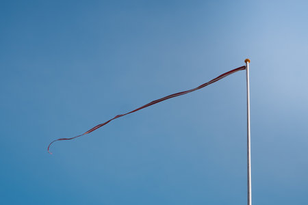 Wind flag flying in the wind on blue sky. flag under blue skyの写真素材