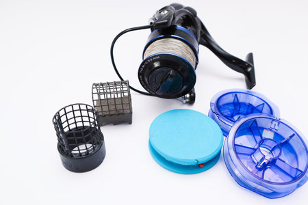 Fisherman equipment. Fishing reel on a white background. Close-up of a spinning fishing reel. Fishing gear on white.の写真素材