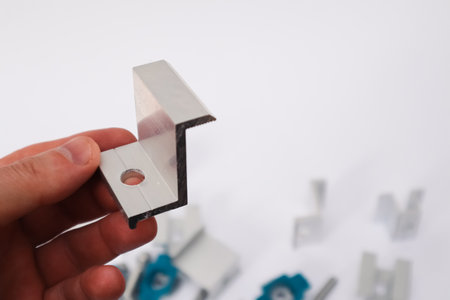 Solar Panel Mounting. Hand Holding End Clamp of Solar PV Panel. Alternative and renewable energy...