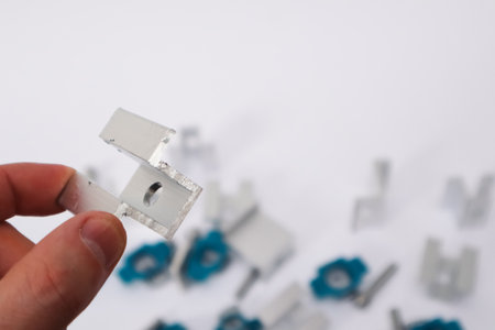 Solar Panel Mounting. Hand Holding End Clamp of Solar PV Panel. Alternative and renewable energy concept.の写真素材