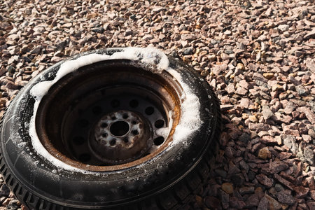 Car wheel low air pressure. Auto repair tires. Car with punctured car tires on a road. Focus on a wheel. Forced emergency stop on the side of roadside, burst tire.の写真素材