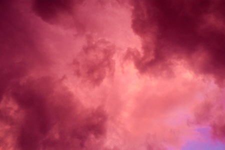 Fiery red storm clouds with dramatic lighting. Red storm clouds background. Dramatic red storm clouds, climate changeの写真素材