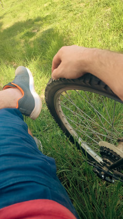 Male bike rider taking a break and enjoying the nature in rural area during weekend morning.の写真素材