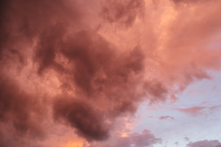 Fiery red storm clouds with dramatic lighting. Red storm clouds background. Dramatic red storm cloudsの写真素材