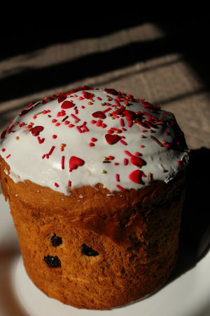 Easter cake decorated with sugar sprinkles. Delicious Easter cake decorated with red sprinkles. Traditional Easter cake with sugar sprinklesの写真素材