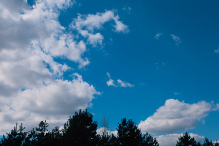 Blue sky and clouds in sunny day. Blue sky and white clouds background. Blue sky clouds background, Beautiful landscape with clouds and sun on sky.の写真素材