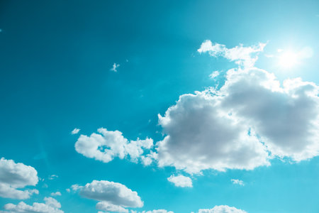 Blue sky and clouds in sunny day. Blue sky and white clouds background. Blue sky clouds background, Beautiful landscape with clouds and sun on sky.の写真素材