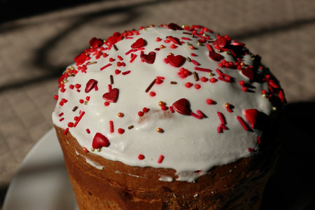 Easter cake decorated with sugar sprinkles. Delicious Easter cake decorated with red sprinkles. Traditional Easter cake with sugar sprinklesの写真素材