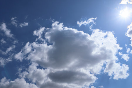 Blue sky and clouds in sunny day. Blue sky and white clouds background. Blue sky clouds background, Beautiful landscape with clouds and sun on sky.の写真素材