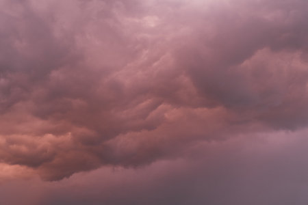 Fiery red storm clouds with dramatic lighting. Red storm clouds background. Dramatic red storm cloudsの写真素材