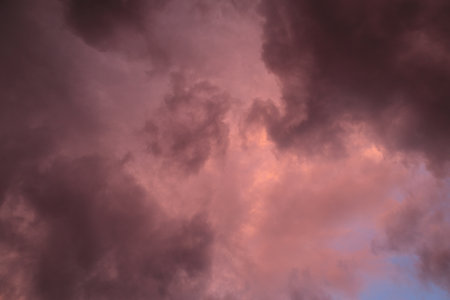 Fiery red storm clouds with dramatic lighting. Red storm clouds background. Dramatic red storm cloudsの写真素材