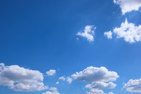 Blue sky and clouds in sunny day. Blue sky and white clouds background. Blue sky clouds background, Beautiful landscape with clouds and sun on sky.の写真素材