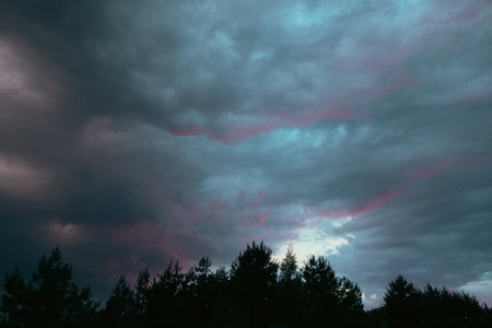 Beautiful colorful stormy sky at sunset. Sunset with mood stormy sky. A dramatic sunset breaking through stormy clouds.の写真素材