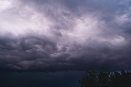 Beautiful colorful stormy sky at sunset. Sunset with mood stormy sky. A dramatic sunset breaking through stormy clouds.の写真素材