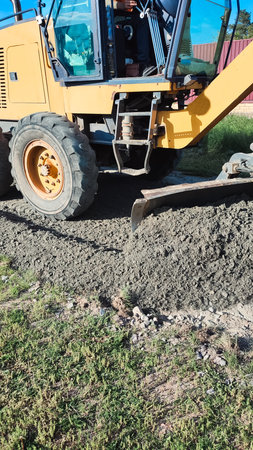 Road Construction. Grader grading gravel for road. New road under construction. Grader leveling a dirt road.の写真素材
