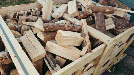 Heap firewood stack, natural wood. Cut firewood top view. Messy pile of firewood on a drive, delivered for the winter stockの写真素材