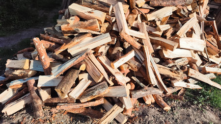 Heap firewood stack, natural wood. Cut firewood top view. Messy pile of firewood on a drive, delivered for the winter stockの写真素材