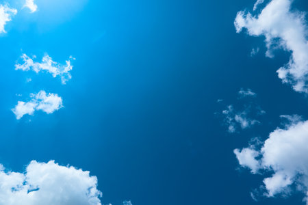 Sunny day. Blue sky and white clouds background. Clear blue sky background with clouds and bright sunの写真素材
