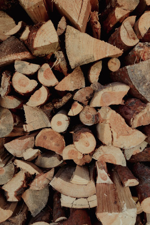 Chopped dry firewood wooden logs stacked for winter fireplace. Cut firewood front view. Log wood backgroundの写真素材