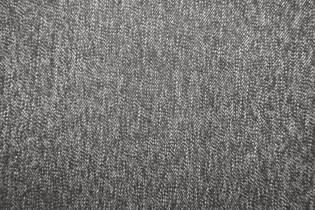 Detailed close-up of gray woven textile fabric with fine texture. Ideal for use as a background, upholstery sample, or design surface texture in product and interior visuals.の写真素材