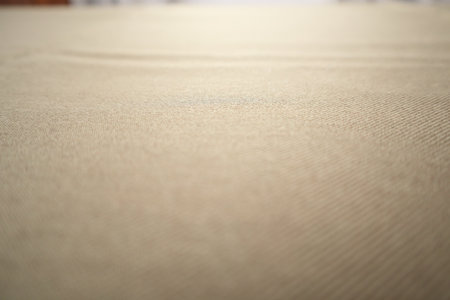 Detailed macro shot of brown fabric showing fine textile weave and smooth texture. Ideal background for design, fashion, upholstery, or material texture concepts.の写真素材