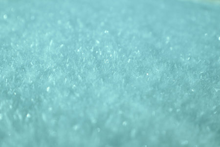 Macro detail of frozen snow surface with glistening ice needles and soft bokeh. Beautiful wintry...