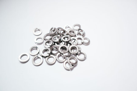 High angle view of a group of split lock washers. Metallic industrial fasteners for preventing...