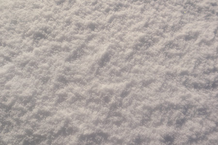 Macro detail of frozen snow surface with glistening ice needles and soft bokeh. Beautiful wintry...
