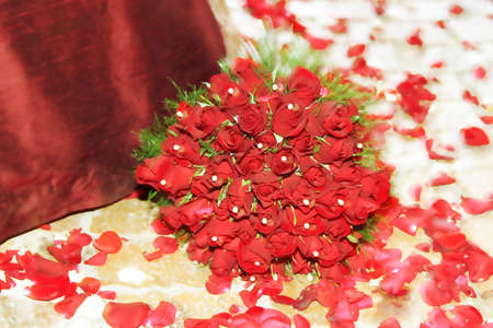 Bunch of red roses with green foliage and white pearls. Soft movementの写真素材