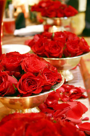 bunches of red  roses in silver bowlsの写真素材