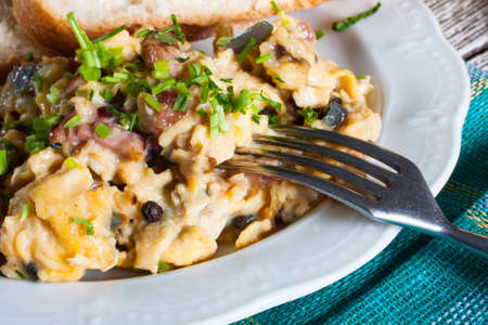 Scrambled eggs with ham and chives.の写真素材