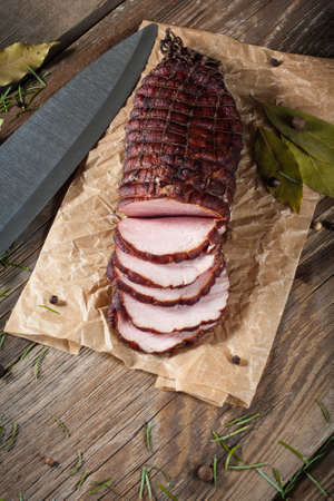 Smoked ham on a chopping board.の写真素材
