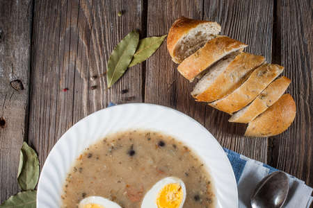 Sour soup with egg and fresh bread.